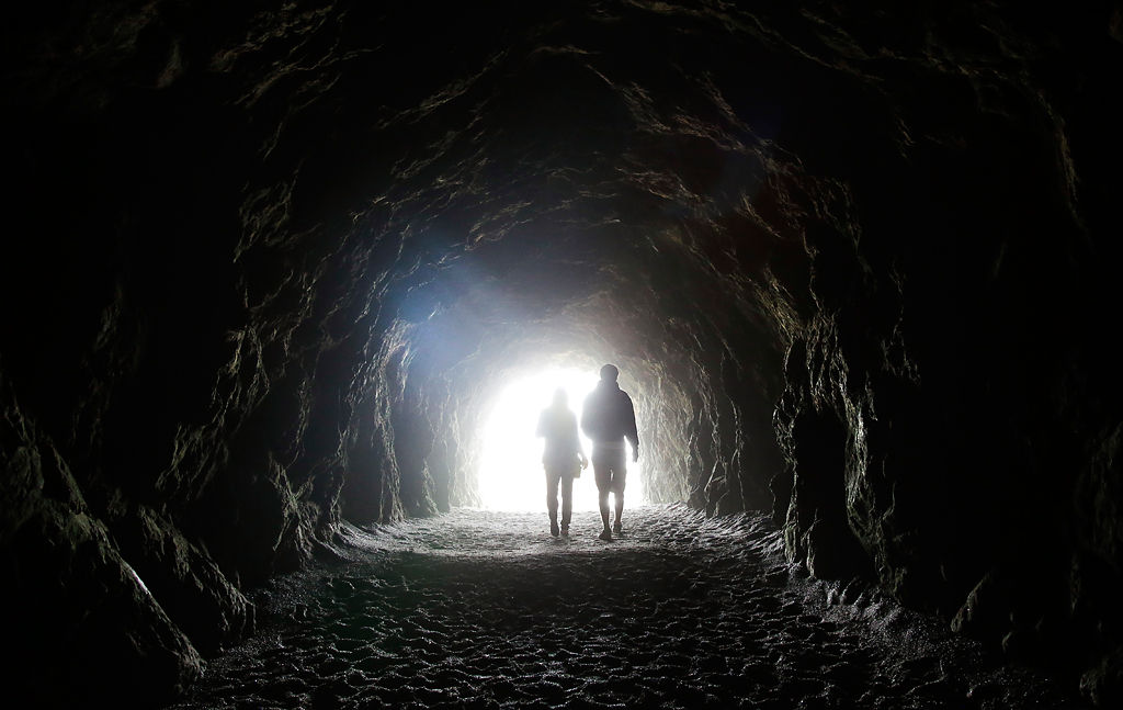 Visitors walk in a Sutro Baths tunnel